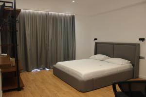 a bedroom with a large bed with white sheets at Vironas Hotel in Himare