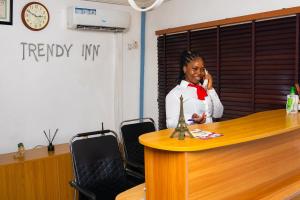 a woman in an office talking on a cell phone at Mende Hotel in Lagos