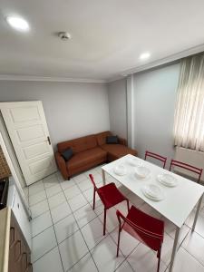 a living room with a white table and red chairs at Istanbul Family Apartment in Istanbul +22 photos