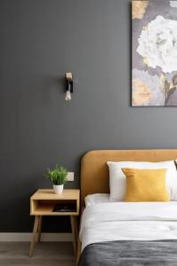 a bedroom with a bed and a table with a plant on it at The Stay Hub in Kyiv