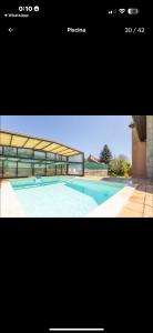 a picture of a swimming pool with a building at Casa Santiago in Argoños