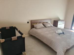 a bedroom with a large bed and a window at Villa avec piscine privée in Oulad Akkou