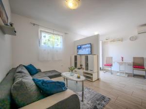 a living room with a couch and a table at LUNA Quiet Retreat, Close to Koper, AirCon, Parking in Ankaran