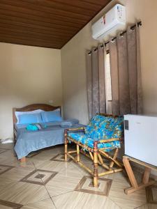 a bedroom with a bed and a bench in it at Refúgio Encantado in Eldorado
