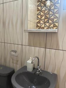 a bathroom with a sink and a mirror and a toilet at Refúgio Encantado in Eldorado +15 photos
