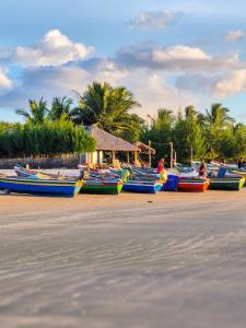 a group of boats sitting on the beach at Casa Concha-Maceio in Camocim