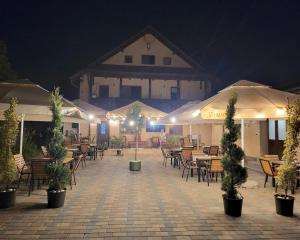 an outdoor patio with tables and chairs at night at Adac Boutique Hotel in Bucharest