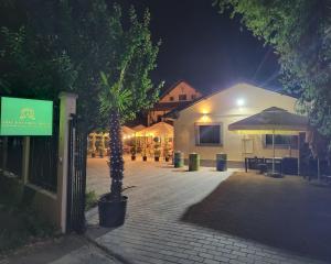 a building with a tree in front of it at night at Adac Boutique Hotel in Bucharest