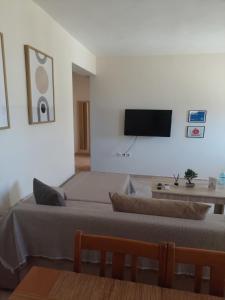 a bedroom with two beds and a tv on the wall at Μοντέρνο Σπίτι in Monemvasia