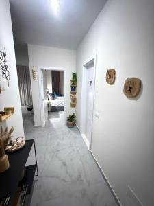 a living room with white walls and a tile floor at Kenya 5 min seaside Vlora Bay in Orikum +15 photos