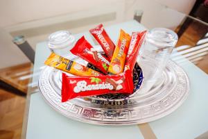 a glass plate with chips and candy on a table at Vila Stanišić apartmani in Vranješ