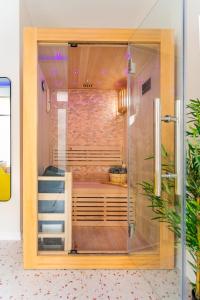 a room with a shower with a staircase in it at Love Room Strasbourg - Jacuzzi & Sauna - Yellow in Strasbourg
