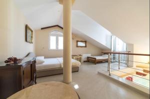 a large room with a bed and a staircase at Turkuaz Boutique Hotel in Sveti Stefan +136 photos