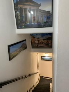 a stairway with paintings on the wall and a stair case at U muragliuni 1 in Lascari