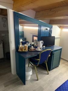 a blue desk with a mirror in a room at U muragliuni 1 in Lascari