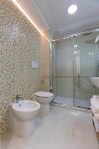 a bathroom with a toilet and a sink and a shower at Brezza Marina Luxury Rooms in Cagliari