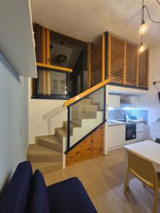 a small kitchen and dining room with a staircase in a house at Orchidea Bianca in Giardini Naxos