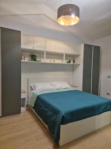 a bedroom with a bed with a blue blanket at Orchidea Bianca in Giardini Naxos +52 photos