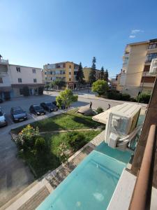 a view of a swimming pool with a chair on a balcony at Te BUNKERI in Ersekë