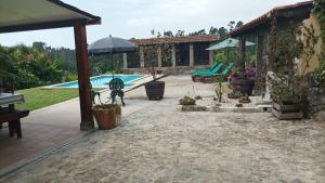 a backyard with a swimming pool and a house at Casa de Penim in Paredes de Coura +36 photos