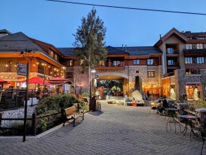 a courtyard with tables and chairs in front of a building at Marriott Grand Res Q1 #3256 in South Lake Tahoe