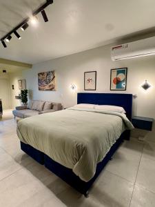 a bedroom with a large bed and a couch at Foster Studio - Park in Buenos Aires +57 photos