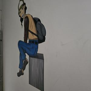 a painting of a man with a backpack on a wall at Balacobaco in Brussels