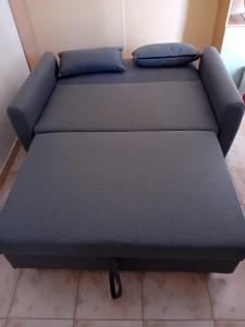 a bed in a room with two pillows on it at The Lion's Head in Olbia