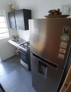 a kitchen with a stainless steel refrigerator and a stove at Hospedaje Toujours in La Paz