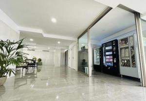 a lobby of a building with a potted plant at Cactus Apartment in Playa Fañabe +46 photos