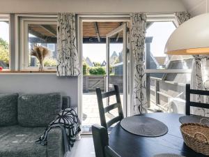 a living room with a table and a couch at 4 person holiday home in Gedser in Gedser