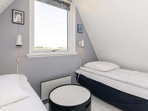 a small room with two beds and a window at 4 person holiday home in Gedser in Gedser
