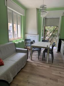 a living room with a couch and a table and chairs at Belvedere MareMonti in Belvedere Ostrense