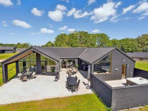 a modular house with a large deck with tables and chairs at 5 star holiday home in Sydals in Sarup