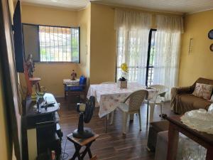 a living room with a table and a couch at Entire home COP 30 next to Hangar in Belém