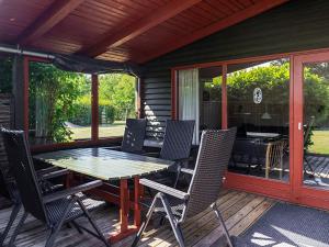 a patio with a table and chairs on a deck at 6 person holiday home in Dannemare-By Traum in Dannemare