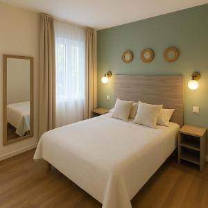 a bedroom with a large white bed and a mirror at Thoiry Étoile Lodge in Thoiry