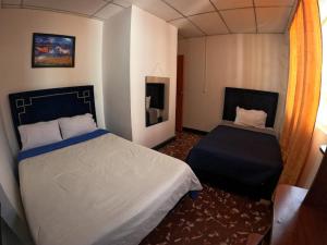 a bedroom with a large bed and a window at Hotel las vegas Málaga in Málaga