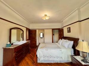 a bedroom with a bed and a dresser and a mirror at PLG House in Brooklyn