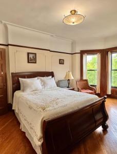 a bedroom with a large bed and a chair at PLG House in Brooklyn +10 photos