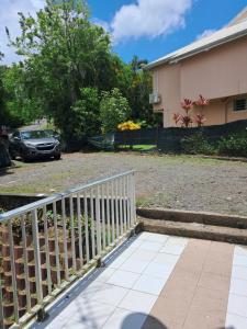 a white fence in front of a house at Océanie in Le Lamentin