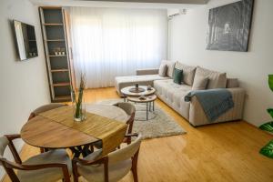 a living room with a couch and a table at Emanuel Apartments in Strumica