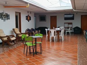 a room with tables and chairs in a room at Hotel las vegas Málaga in Málaga