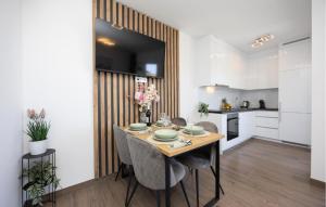 a kitchen and dining room with a table and chairs at 2 Bedroom Lovely Apartment In Stanici in Stanići