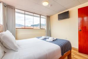 Postel nebo postele na pokoji v ubytování Cusco Hostal Qolla Wasi-II
