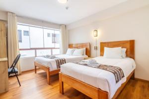 Postel nebo postele na pokoji v ubytování Cusco Hostal Qolla Wasi-II