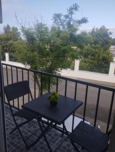 a table and two chairs on a balcony at Green Passion in Ponta Delgada +2 photos