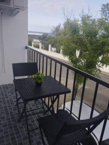 a table and chairs sitting on a balcony with a view at Green Passion in Ponta Delgada