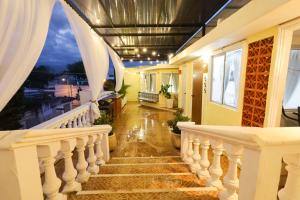 a staircase with white railings in a house at Casa Bien Estar - Centro Merida in Mérida
