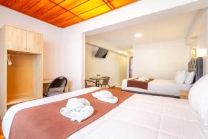 Postel nebo postele na pokoji v ubytování Cusco Hostal Qolla Wasi-II